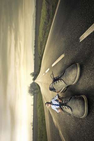 Man Stuck in Giant Shoes in the Middle of the Road Journal de Cool Image